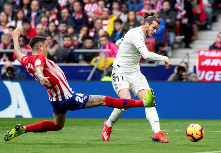 El delantero galés del Real Madrid Gareth Bale (d) y el defensa uruguayo del Atlético de Madrid José María Giménez durante el partido de la vigésimo tercera jornada de Liga que disputaron en el estadio Wanda Metropolitano de Madrid. EFE